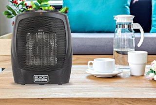 a space heater on a  wooden table 