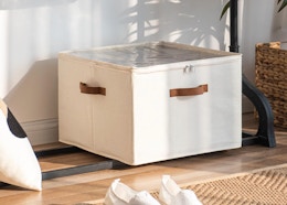 a shoe organizer on the bottom of a clothing rack 