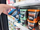 hand grabbing a protein pints ice cream off a target shelf