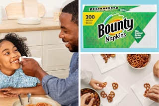 A dad wipes his daughter's face with a Bounty napkin, a 200-pack of Bounty napkins, hands eating pretzels off Bounty napkins
