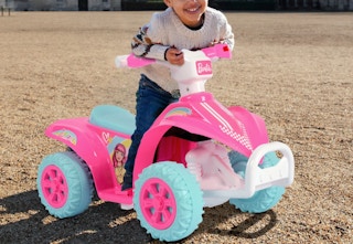 child on a Barbie ride-on