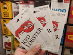 a hand holding Red Lobster gift cards