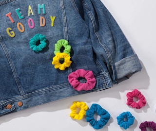 Colorful scrunchies on a jean jacket on a table
