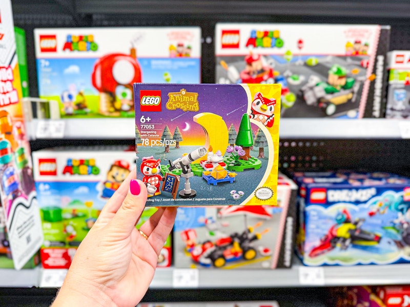 hand holding lego animal crossing set in front of lego sets in walmart aisle