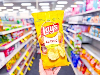 hand holding lay's chips cvs