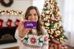 a woman holding a zulily gift card