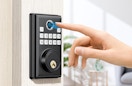 a person using their finger on a keypad to unlock a door 