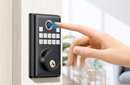 a person using their finger on a keypad to unlock a door 