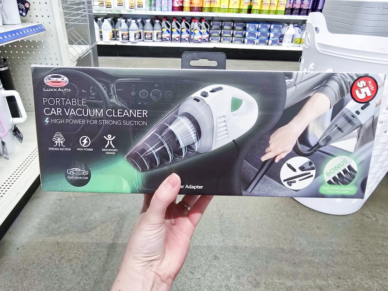 person holding a portable car vacuum