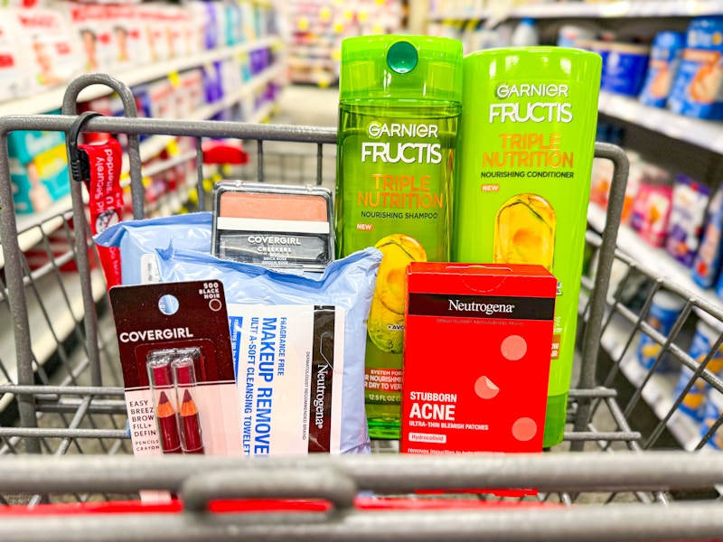 makeup, makeup wipes, acne patches, and shampoo in a cart