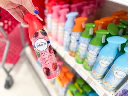 hand holding a febreze air effects spray in front of a target shelf