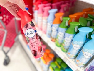hand holding a febreze air effects spray in front of a target shelf