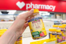 person holding a bottle of nature made multivitamins
