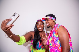 Couple posing for a selfie in Barbie roller skating halloween outfits