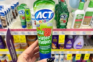 hand holding act kids toothpaste
