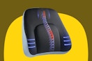 A black lumbar support pillow with extra support in the middle and red and blue arrows to represent the support.