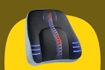 A black lumbar support pillow with extra support in the middle and red and blue arrows to represent the support.