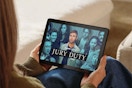 a woman using an amazon fire 10 tablet