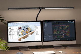 LED desk lamps illuminating dual monitors