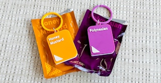 Two Chick-fil-A sauce keychains on a table