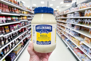 hand holding a hellmann's mayo bottle in a target aisle
