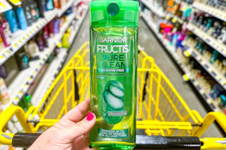 hand holding dollar general fructis shampoo