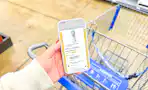 hand holding a smartphone displaying a 1-clip coupon deal