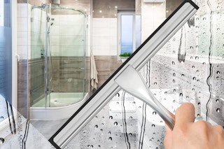 a shower door being cleaned