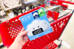 hand holding a kids' wake up light alarm clock in front a parked target cart