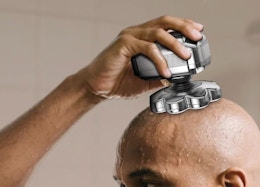 a person using a silver head shaver