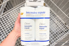 hand holding dove hair care set over shopping cart