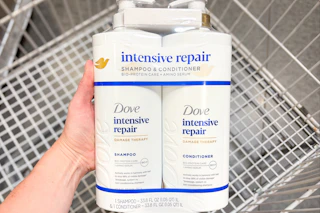 hand holding dove hair care set over shopping cart