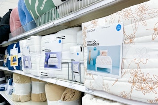 room essentials satin quilts sitting on a target shelf