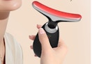 a person holding a light therapy massager 