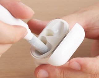 a small tool cleaning an AirPod case 