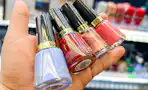 hand holding bottles of revlon nail polish