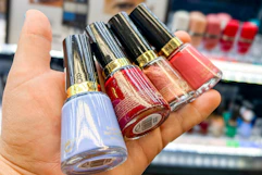 hand holding bottles of revlon nail polish