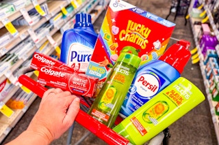 person pushing a cart with colgate, purex, garnier, lucky charms, and persil in it