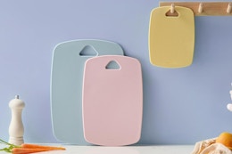 three colorful cutting boards against a wall