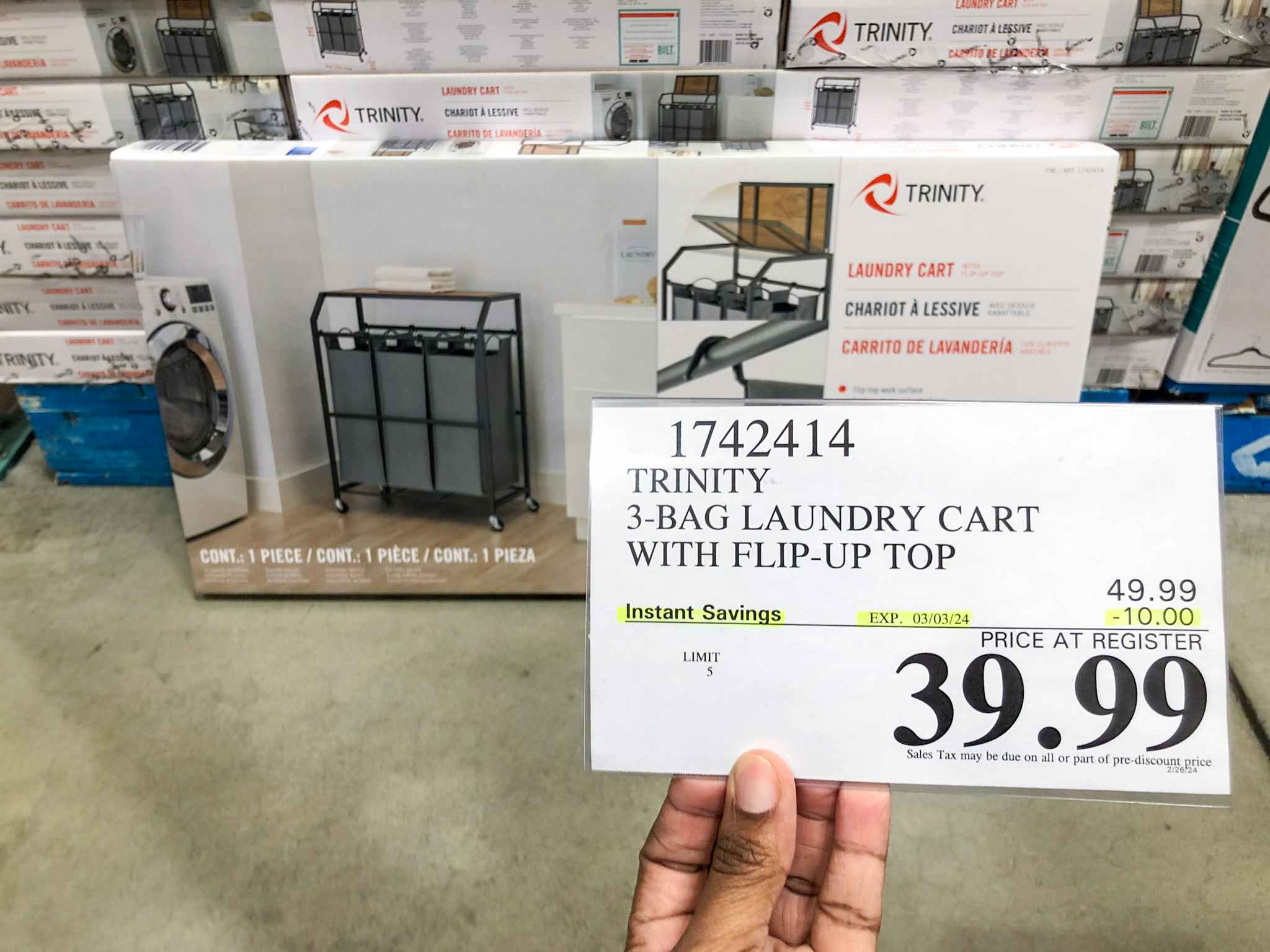 person holding a $39.99 price tag in front of a laundry cart