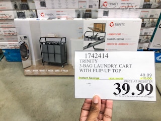 person holding a $39.99 price tag in front of a laundry cart