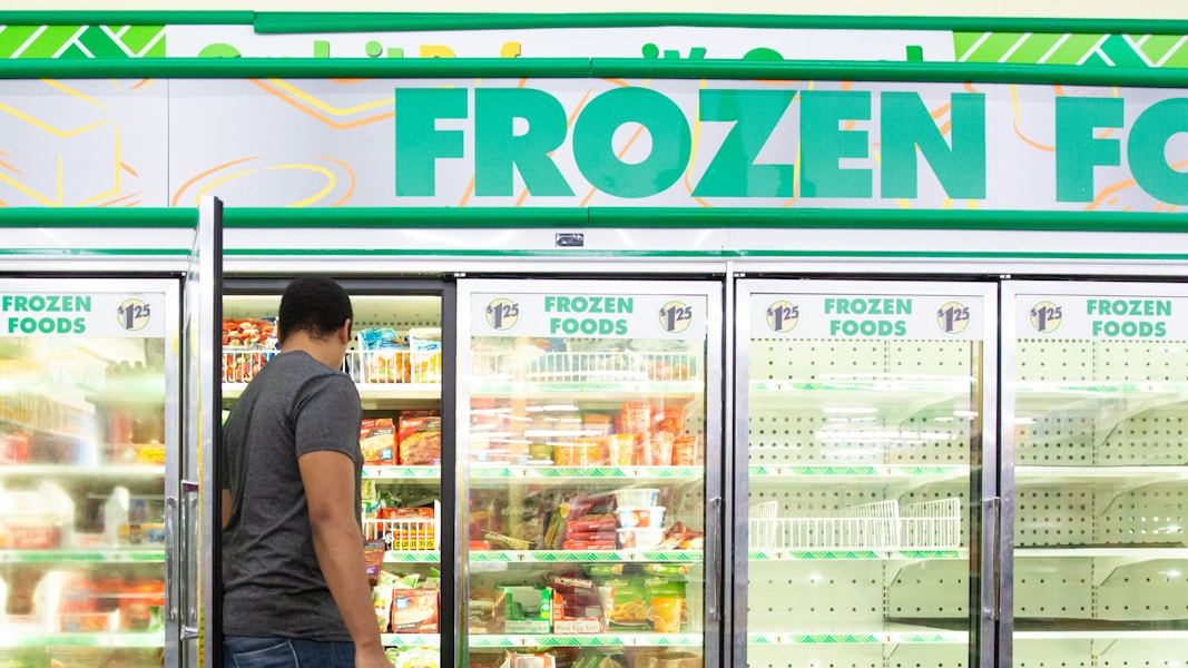 Person grabbing items inside a Dollar Tree Aisle 