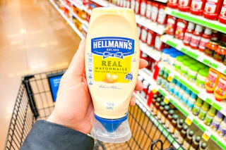 hand holding a bottle of hellmanns mayo