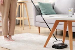 a carpet sweeper being used on a rug