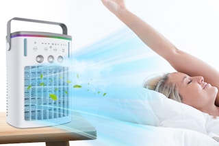 a woman sitting near a portable a/c