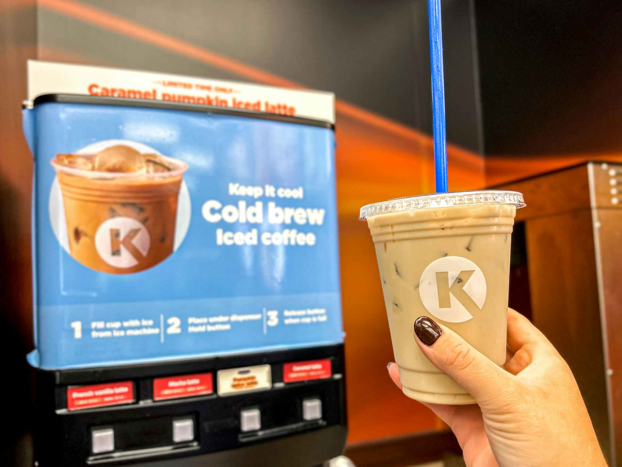 a person holding up a circle k coffee