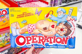 person holding an operation board game
