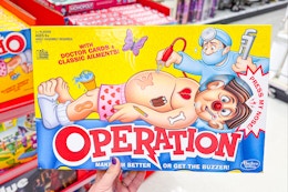 person holding an operation board game