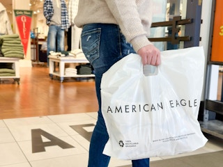 a woman talking out of an american eagle with bag