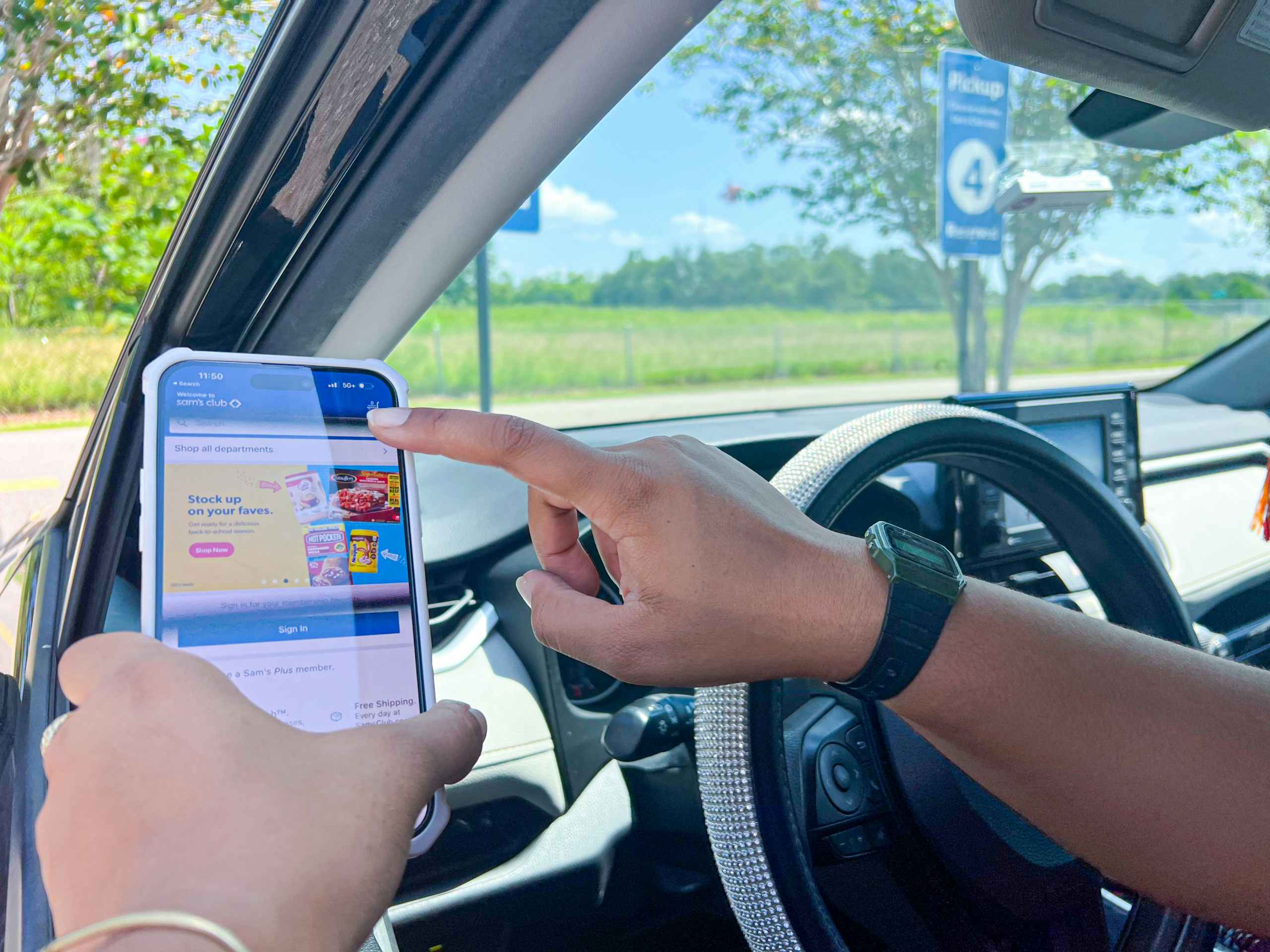 Person in their car holding a phone.